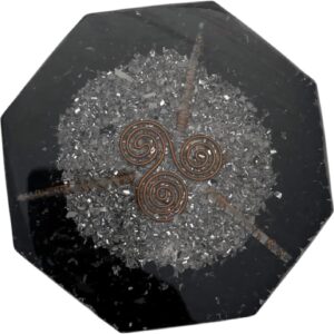 Schwarzer CHONIT Orgonit-Untersetzer mit sichtbaren Steinen, Metalleinschlüssen und kupferfarbenem Spiralmotiv.
